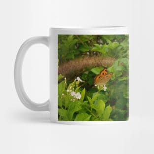 Vibrant Serenity: Orange Butterflies on Green Leaves Mug